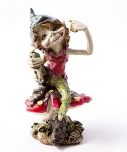 A whimsical figurine of a Pesky Cornish Piskie sitting confidently atop a large, colorful mushroom. The character has a playful expression,