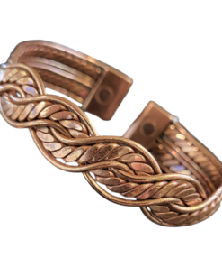 Magnetic copper therapy bracelet in an open cuff style, featuring an intricate braided leaf-pattern design with polished copper and brass tones, complemented by rope-edged borders and magnets at each end for potential arthritis relief, improved circulation, and overall wellness benefits.