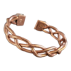 Handmade copper magnetic bracelet featuring an intricate twisted braid design, open cuff style, with magnets set into each end for potential therapeutic benefits.