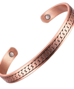 A slim copper open cuff bangle with an engraved infinity-loop design running along its length. The ends feature round discs set with large magnets, complemented by smaller inset magnets inside near each end, merging decorative style with potential magnetic therapy benefits.