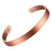 A narrow copper open cuff bangle with a smooth, brushed matte finish for a sleek and minimalist look. The interior is fitted with multiple round inset magnets—four on each end—combining understated style with potential magnetic therapy benefits.