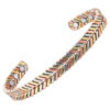 A copper open cuff bangle with a herringbone pattern formed from alternating segments of rose gold-toned copper, golden brass, and silvery nickel. The intricate tri-metal design continues along the entire band, while the smooth interior is fitted with multiple round inset magnets near each end, combining decorative detail with potential magnetic therapy benefits.