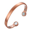 A copper open cuff bangle with a smooth brushed finish for a sleek, minimalist look. The ends are rounded discs each inset with a large magnet, while additional smaller magnets are positioned on the inner surface near each end, combining simple elegance with potential magnetic therapy benefits.