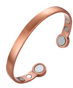 A copper open cuff bangle with a smooth brushed finish for a sleek, minimalist look. The ends are rounded discs each inset with a large magnet, while additional smaller magnets are positioned on the inner surface near each end, combining simple elegance with potential magnetic therapy benefits.