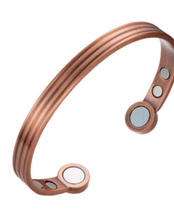 A copper open cuff bangle with a triple-groove design along its outer surface, giving it a sleek, textured appearance. The ends are rounded discs inset with large magnets, while additional smaller magnets are positioned inside near each end, combining stylish detailing with potential magnetic therapy benefits.