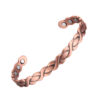 A copper open cuff bangle featuring a raised braided design along its outer surface for a textured, intertwined look. The interior is smooth and fitted with multiple round inset magnets near each end, combining decorative craftsmanship with potential magnetic therapy benefits.