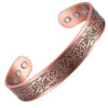 A wide copper open cuff bangle featuring an intricate engraved Celtic knot design along its length. The interior of the bracelet has a smooth finish and contains multiple round inset magnets positioned near each end, combining decorative craftsmanship with potential magnetic therapy benefits.