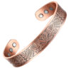 A wide copper open cuff bangle adorned with an intricate engraved Nordic-inspired pattern featuring stylised birds and geometric motifs. The interior is smooth with a polished finish and contains multiple round inset magnets near each end, combining decorative artistry with potential magnetic therapy benefits.