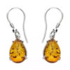 Sterling silver drop earrings with rectangular Baltic amber stones and delicate silver leaf detail.