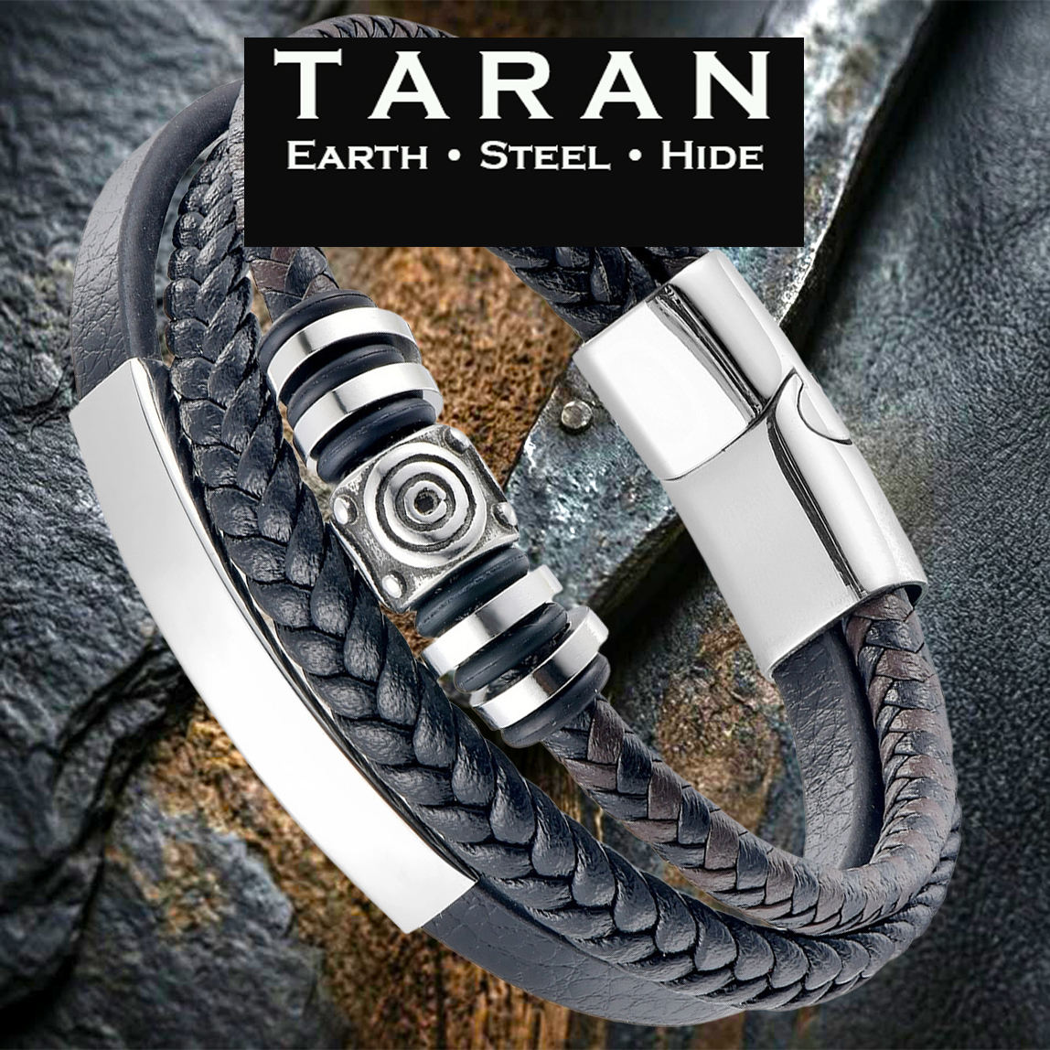 A Taran men's multi-strand black leather bracelet featuring three distinct layers: a smooth band with a curved silver stainless steel bar, a round-braided strand, and a center strand stacked with polished silver-toned geometric beads. The piece includes a high-shine silver magnetic clasp, displayed against a rugged, dark textured stone and rustic slate background with the Taran logo.