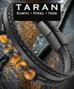 A Taran men's multi-strand black leather bracelet featuring three distinct layers: a strand of polished, natural golden-brown tiger's eye gemstone beads with black metal end caps, a rugged round-braided leather plait, and a smooth flat leather band. The piece features a sleek satin-black magnetic closure.