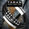 A Taran men's black leather silver ID bar bead bracelet featuring an asymmetrical tri-strand design. The layout includes a thick row of tightly woven black braided leather on top, a central pebbled leather strand hosting a detailed silver cylindrical bead with antiqued scrollwork filigree patterns, and a smooth bottom leather strand secured behind a long, curved, mirror-polished silver stainless steel ID bar. The strands are bound by polished silver industrial spacer rings and connect into a heavy-duty silver magnetic slide clasp.