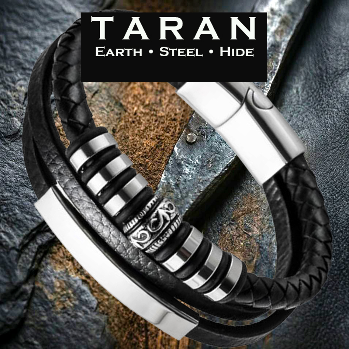A Taran men's black leather silver ID bar bead bracelet featuring an asymmetrical tri-strand design. The layout includes a thick row of tightly woven black braided leather on top, a central pebbled leather strand hosting a detailed silver cylindrical bead with antiqued scrollwork filigree patterns, and a smooth bottom leather strand secured behind a long, curved, mirror-polished silver stainless steel ID bar. The strands are bound by polished silver industrial spacer rings and connect into a heavy-duty silver magnetic slide clasp.