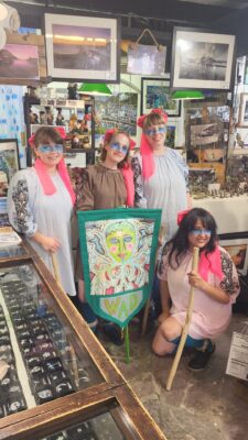 Four members of The Wad Morris dancers inside Joan The Wad shop Polperro.
