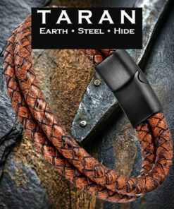 Men's TARAN double-strand cognac brown braided leather bracelet with two-tone weathered hide and a brushed black magnetic steel clasp, displayed on a dark slate and wood background.