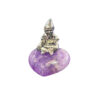 A small pewter Cornish piskey figurine with a pointed hat sitting atop a heart-shaped, vibrant purple amethyst gemstone