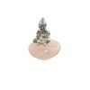 A small pewter Cornish piskey figurine with a pointed hat sitting atop a heart-shaped, soft pink rose quartz gemstone base.